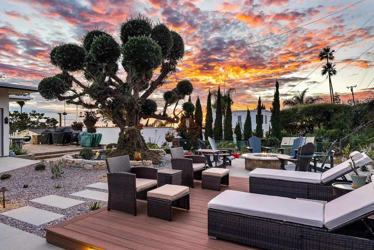 Sculpted topiary and wood deck lounge area at sunset in a Palos Verdes Estates backyard